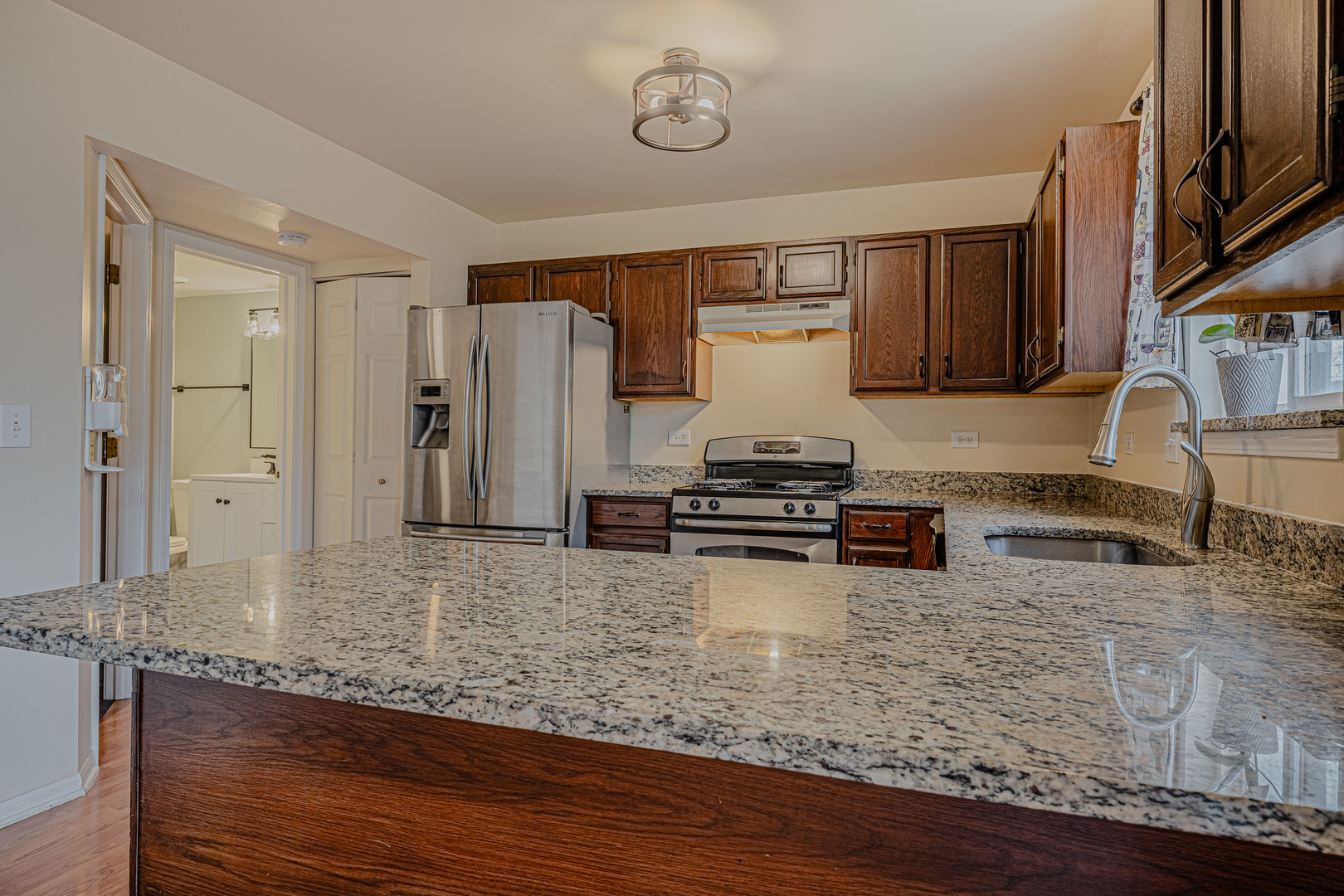 6743 Nantucket Court, Unit 6743 Gurnee, IL 60031 - Photo 9 of 30 a kitchen with stainless steel appliances granite countertop a sink stove and cabinets
