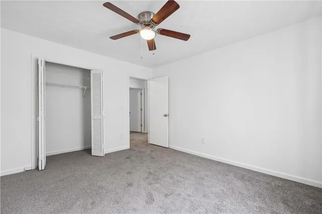 an empty room with a ceiling fan and a ceiling fan