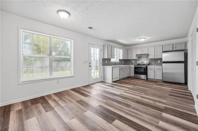 a view of a kitchen with a stove cabinets and wooden floor