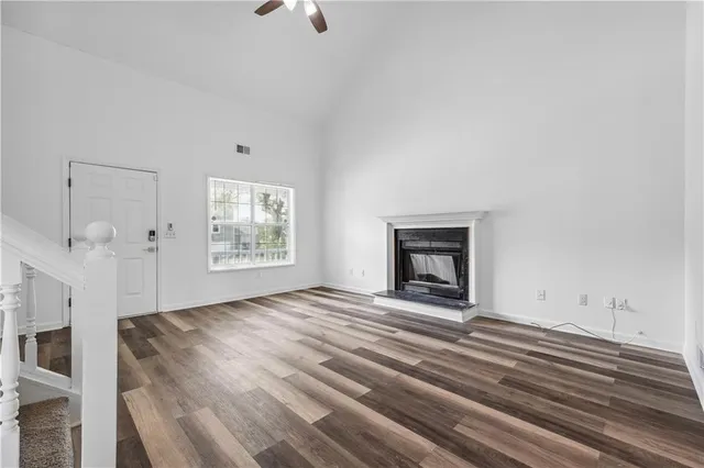 a view of an empty room with a fireplace and a window
