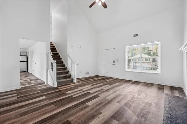 a view of an empty room with stairs and ventilation
