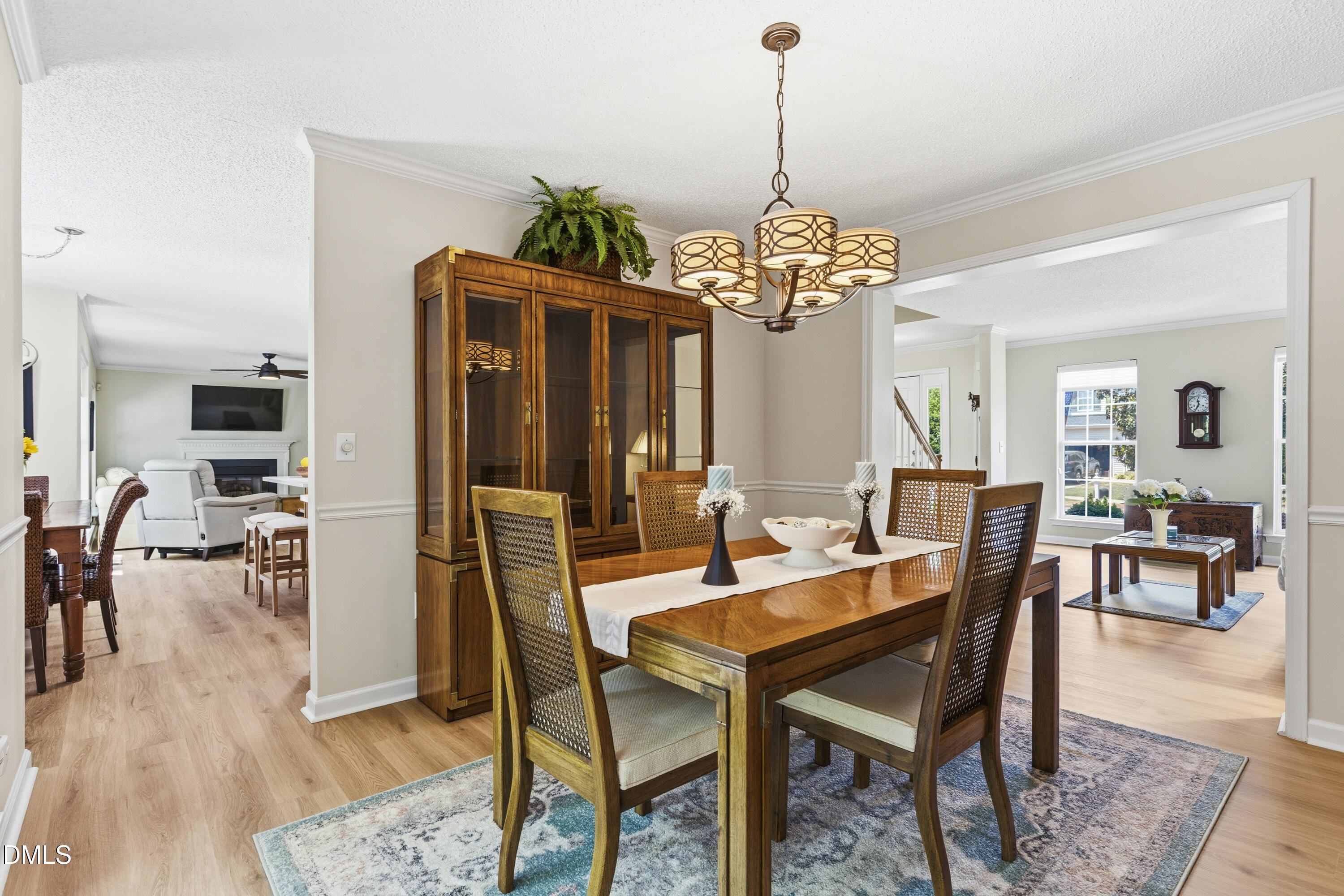 1211 Waterford Green Drive Apex, NC 27502 - Photo 16 of 53 a view of a dining room with furniture and wooden floor