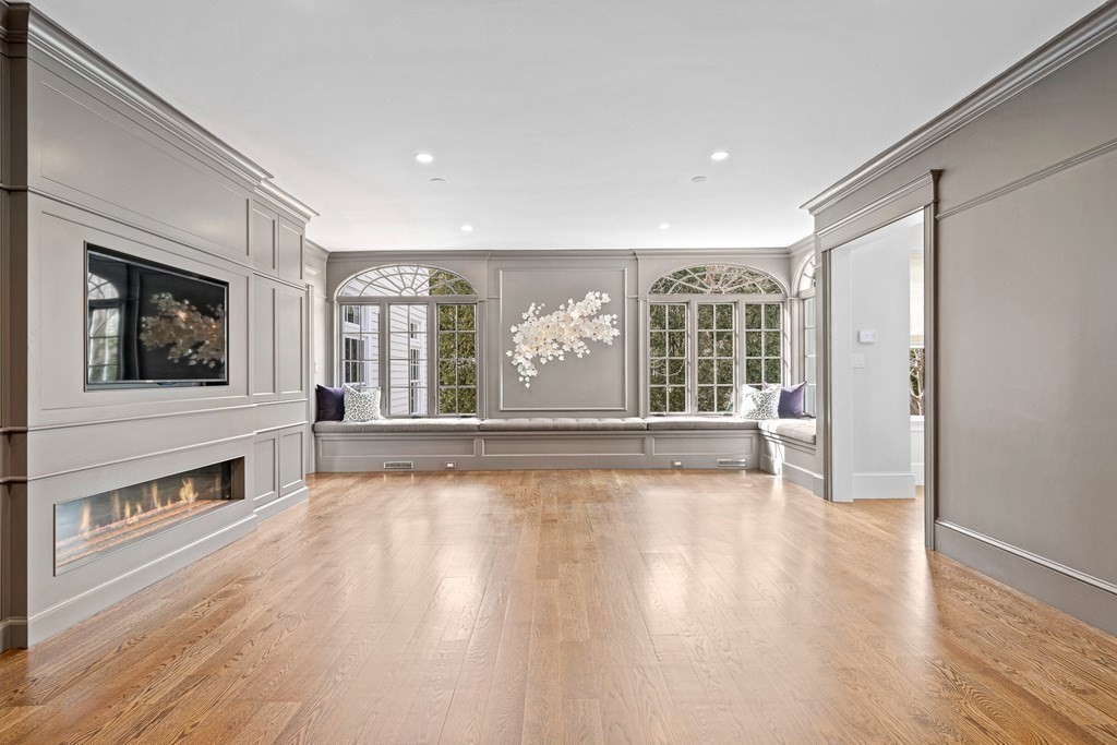 48 Everett Avenue Winchester, MA 01890 - Photo 13 of 42 a view of an empty room with wooden floor and a window
