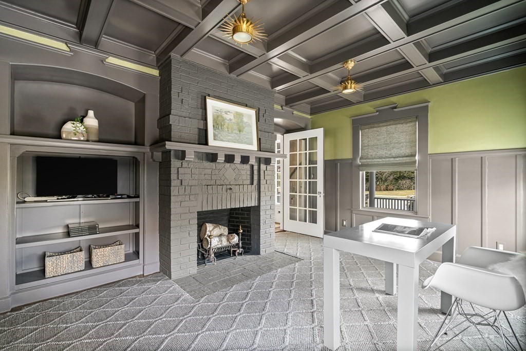 48 Everett Avenue Winchester, MA 01890 - Photo 18 of 42 a living room with furniture and a fireplace