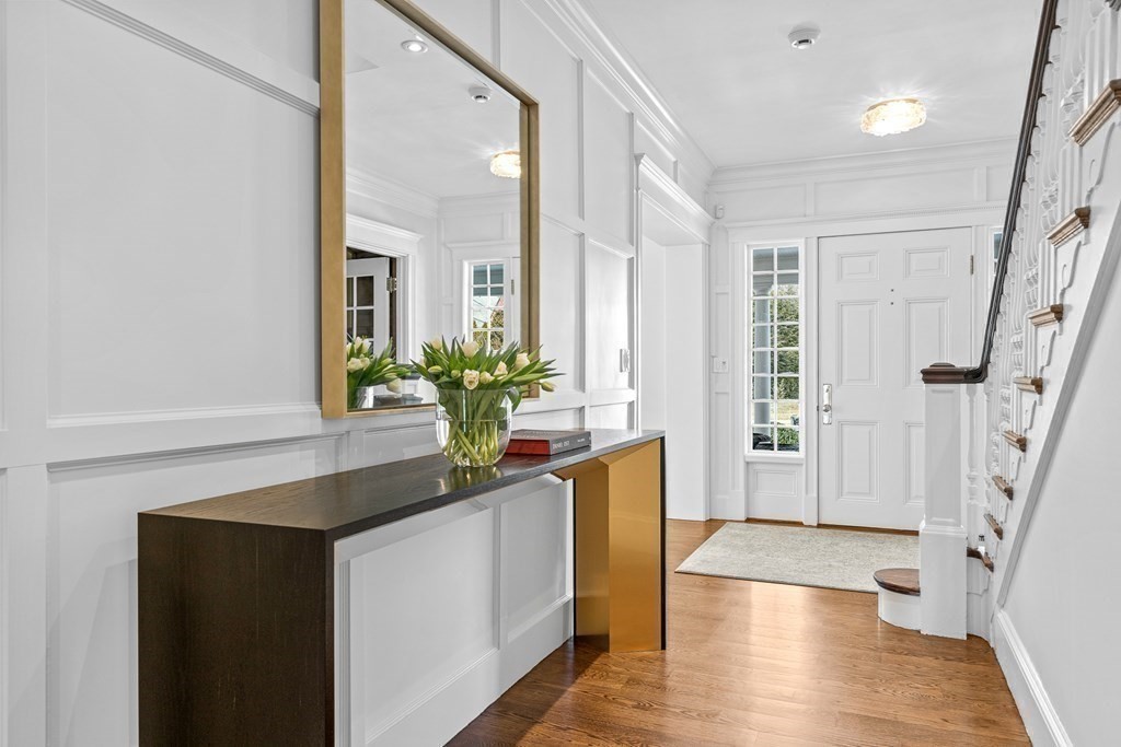 48 Everett Avenue Winchester, MA 01890 - Photo 19 of 42 a hallway with wooden floor and front door
