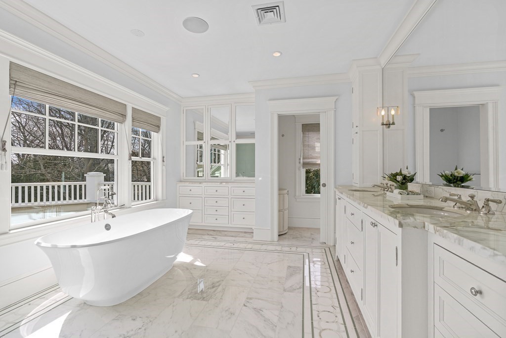 48 Everett Avenue Winchester, MA 01890 - Photo 26 of 42 a spacious bathroom with a double vanity sink a mirror and a bathtub