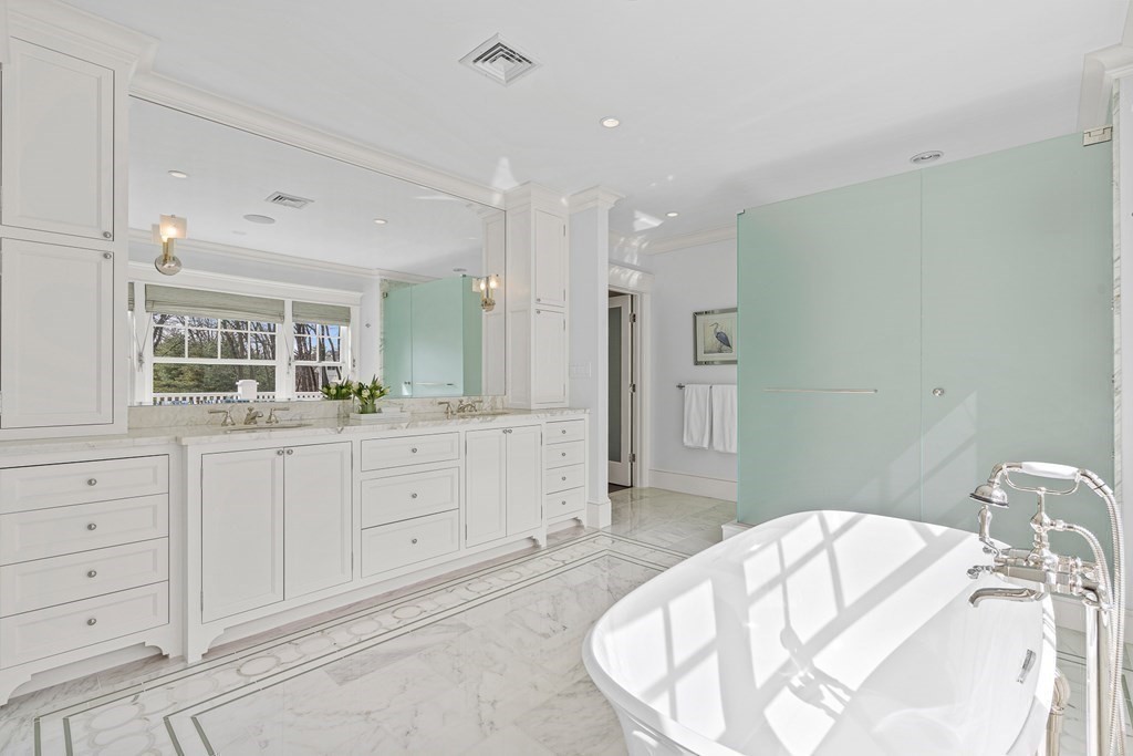 48 Everett Avenue Winchester, MA 01890 - Photo 27 of 42 a spacious bathroom with a bathtub sink and mirror