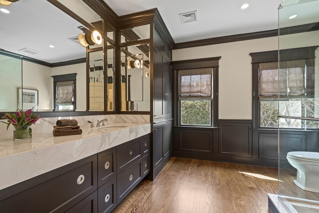 48 Everett Avenue Winchester, MA 01890 - Photo 28 of 42 a bathroom with a double vanity sink a mirror and a shower
