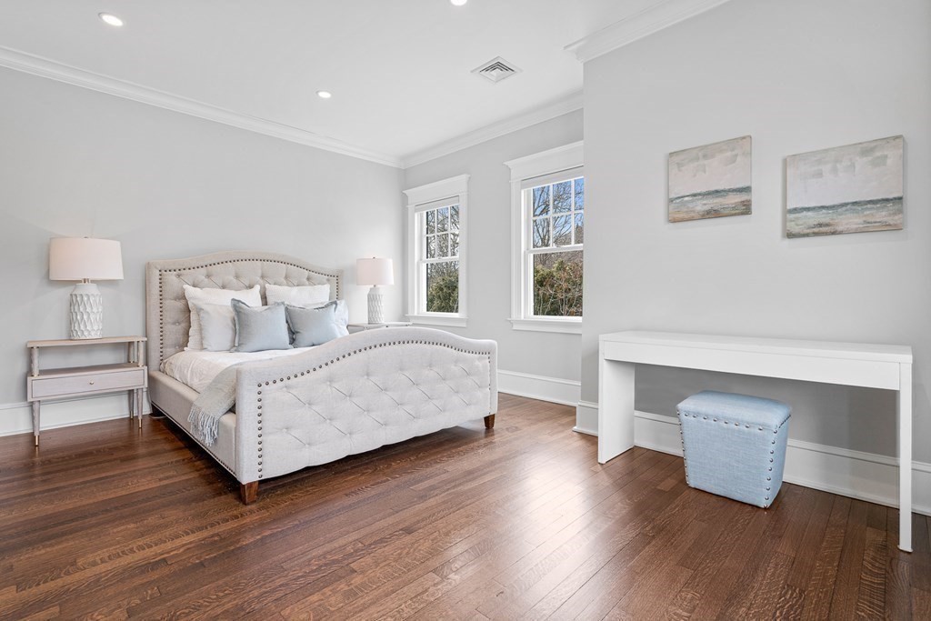 48 Everett Avenue Winchester, MA 01890 - Photo 30 of 42 a bedroom with a bed and wooden floor