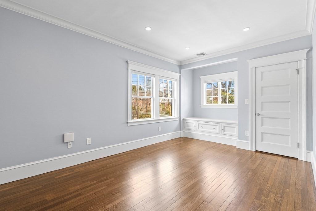 48 Everett Avenue Winchester, MA 01890 - Photo 31 of 42 an empty room with wooden floor and windows
