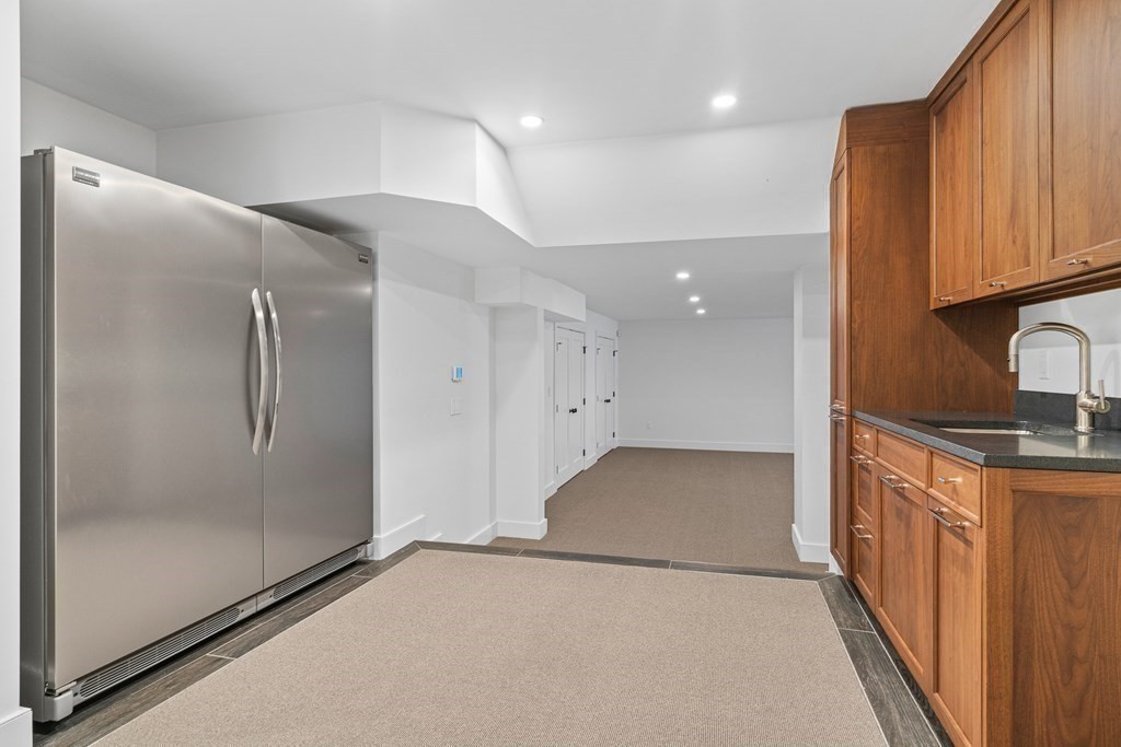 48 Everett Avenue Winchester, MA 01890 - Photo 38 of 42 a view of a hallway with stainless steel appliances granite countertop cabinets and a counter top space