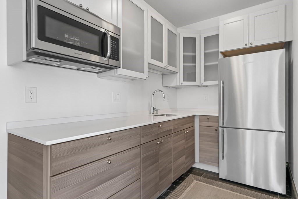 48 Everett Avenue Winchester, MA 01890 - Photo 39 of 42 a kitchen with stainless steel appliances white cabinets and wooden cabinets