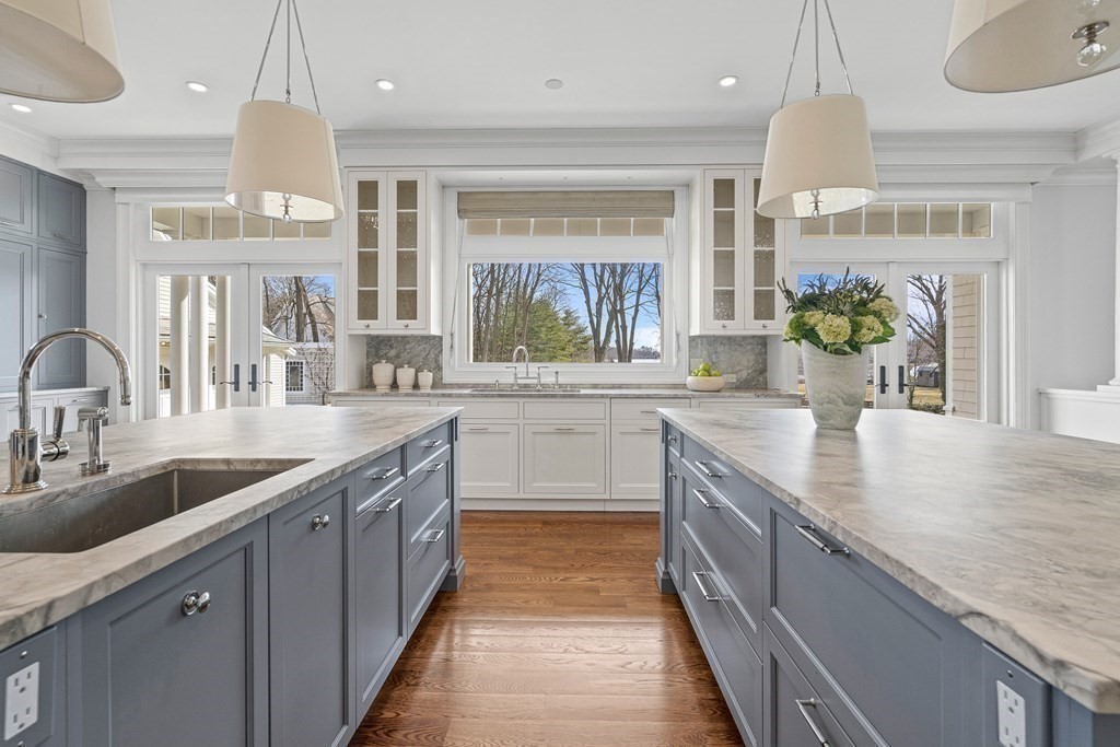 48 Everett Avenue Winchester, MA 01890 - Photo 7 of 42 a kitchen with stainless steel appliances a sink stove and cabinets