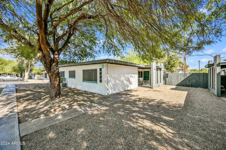 1518 West Colter Street, Unit 10 Phoenix, AZ 85015 - Photo 1 of 14 a view of a house with a tree in the background