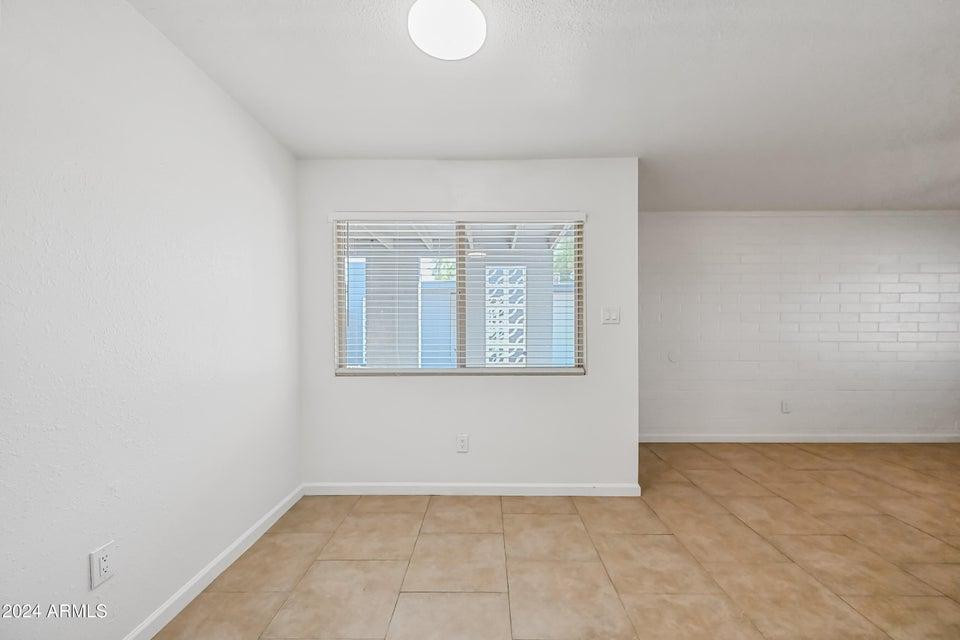 1518 West Colter Street, Unit 10 Phoenix, AZ 85015 - Photo 9 of 14 a view of an empty room with a window
