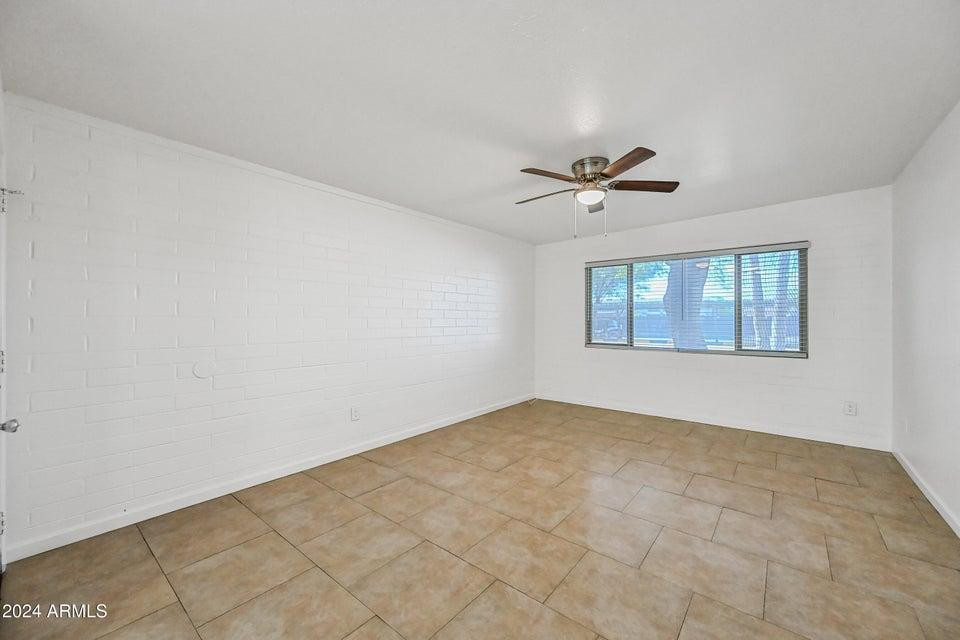 1518 West Colter Street, Unit 10 Phoenix, AZ 85015 - Photo 10 of 14 an empty room with fan and windows