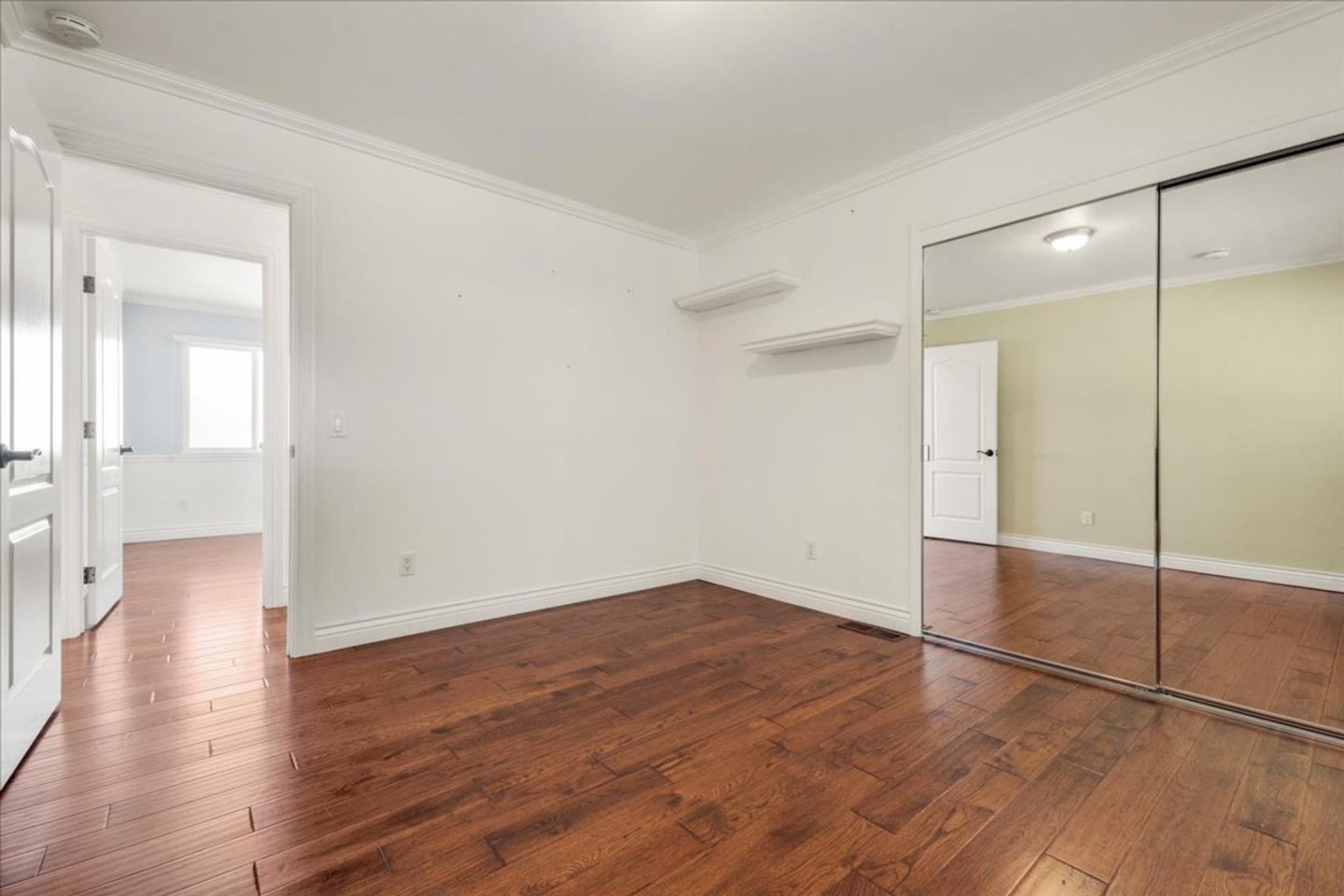15 Mentone Road Carmel, CA 93923 - Photo 22 of 47 an empty room with wooden floor and mirror