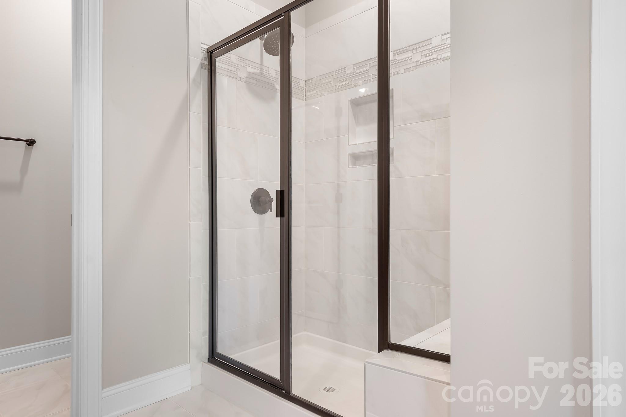 1909 Lotus Lane Denver, NC 28037 - Photo 16 of 44 a bathroom with a glass shower door