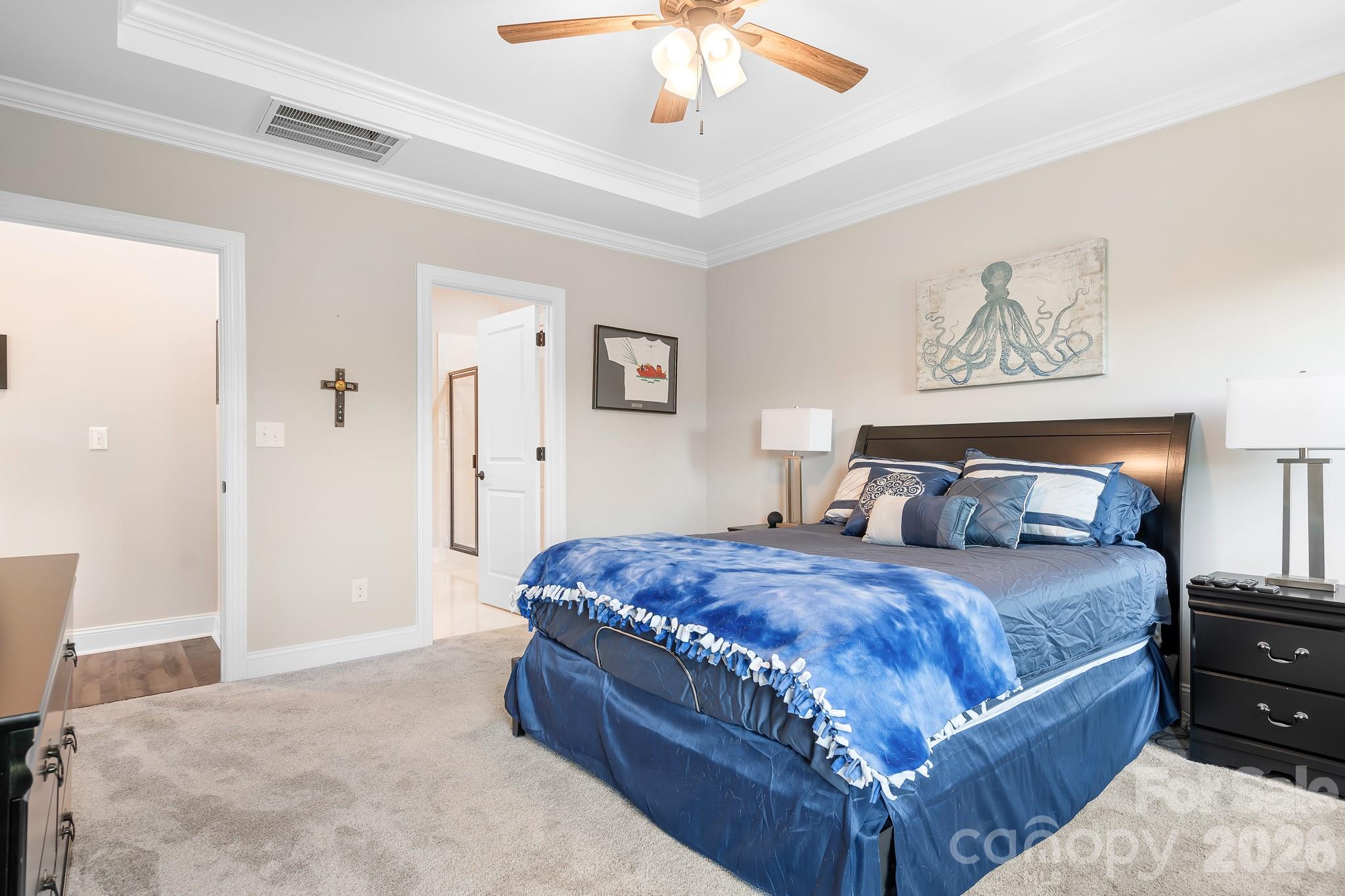 1909 Lotus Lane Denver, NC 28037 - Photo 18 of 44 a bedroom with a large bed and a chandelier