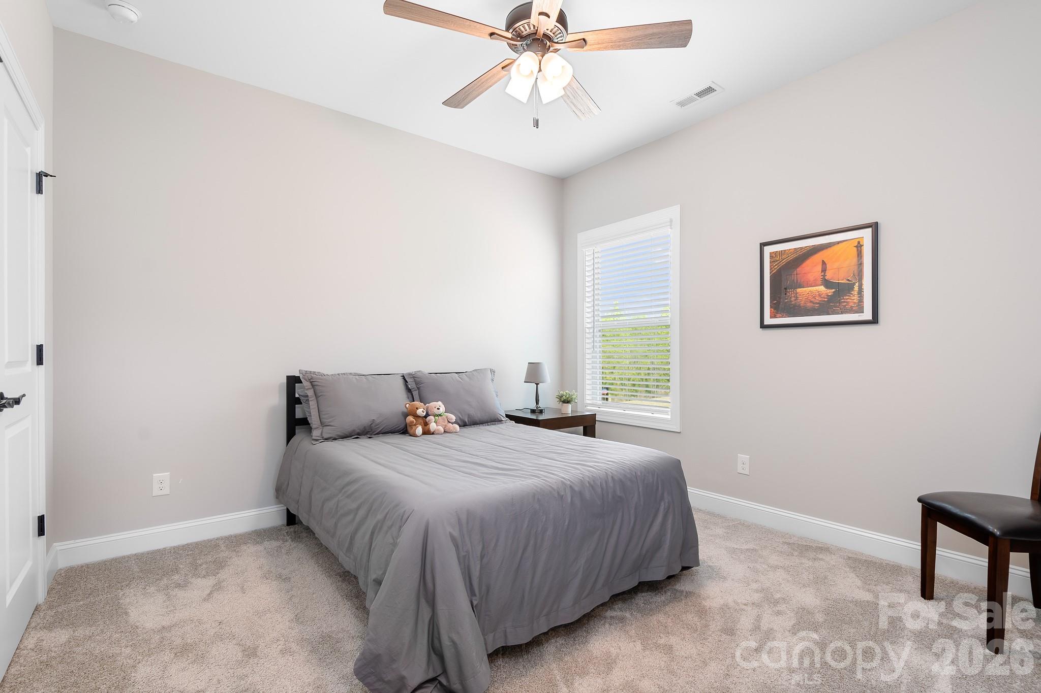 1909 Lotus Lane Denver, NC 28037 - Photo 19 of 44 a bedroom with a bed and a chandelier