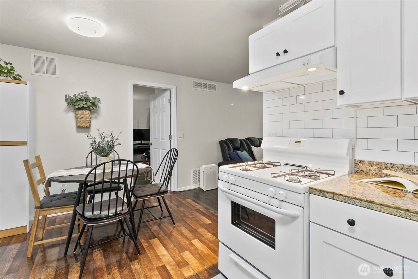 26604 191st Place Southeast Covington, WA 98042 - Photo 11 of 34 a kitchen with a table chairs and a stove