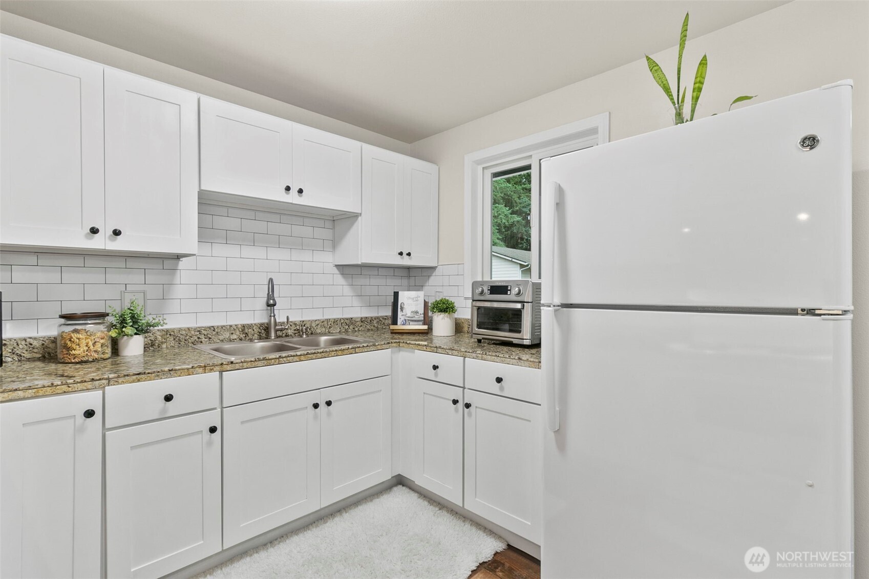 26604 191st Place Southeast Covington, WA 98042 - Photo 10 of 34 a kitchen with a sink a refrigerator and cabinets