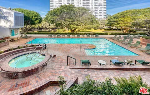 a view of a swimming pool with a yard and sitting space