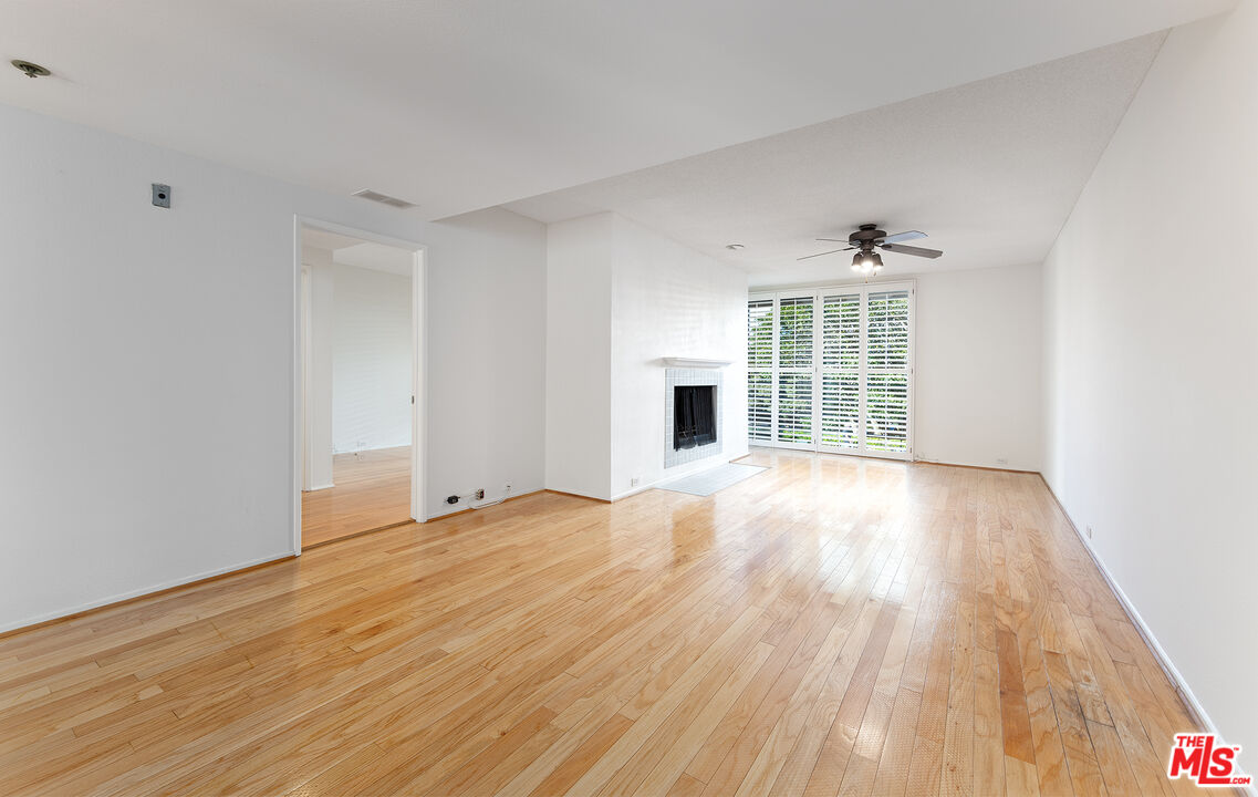 2910 Neilson Way, Unit 308 Santa Monica, CA 90405 - Photo 12 of 32 a view of an empty room with wooden floor and a window