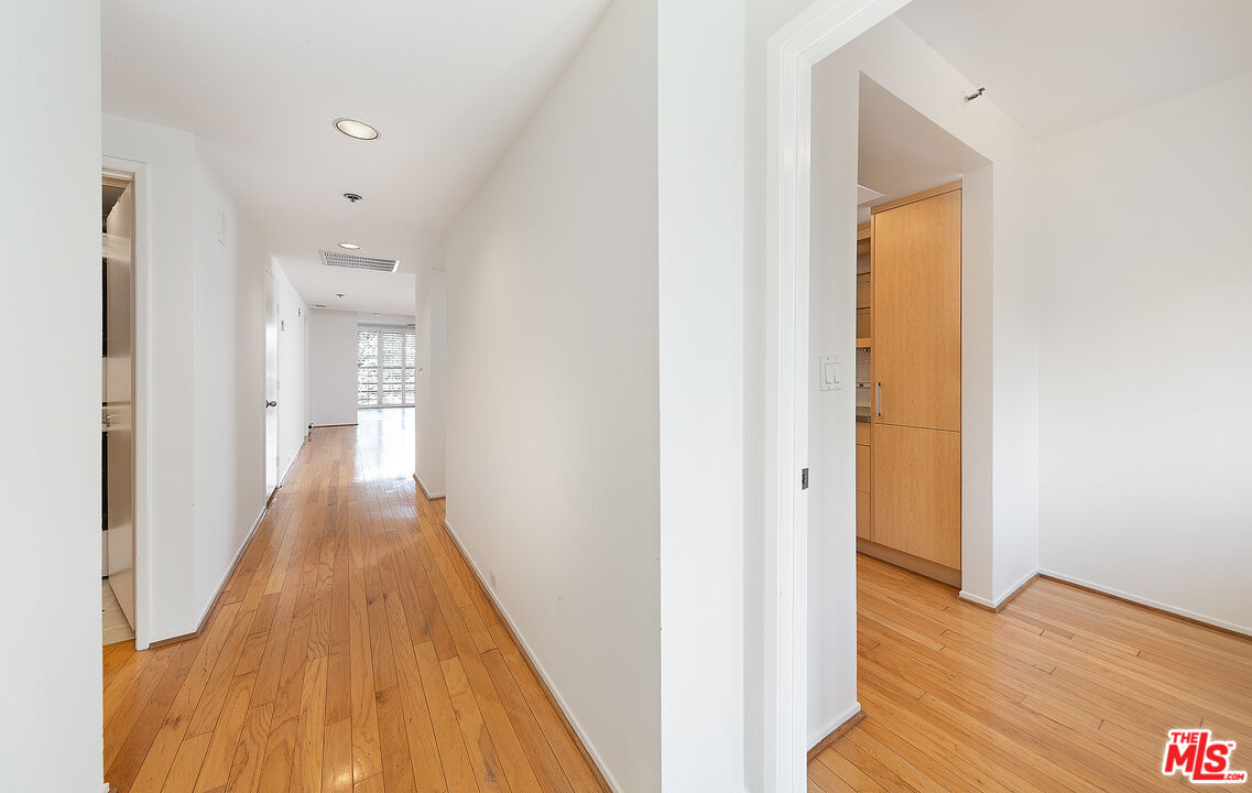 2910 Neilson Way, Unit 308 Santa Monica, CA 90405 - Photo 3 of 32 a view of a hallway with wooden floor