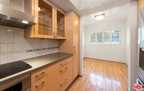 a kitchen with a wooden floor and a window