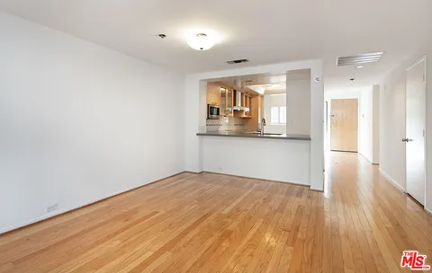 a view of a kitchen with wooden floor and a sink