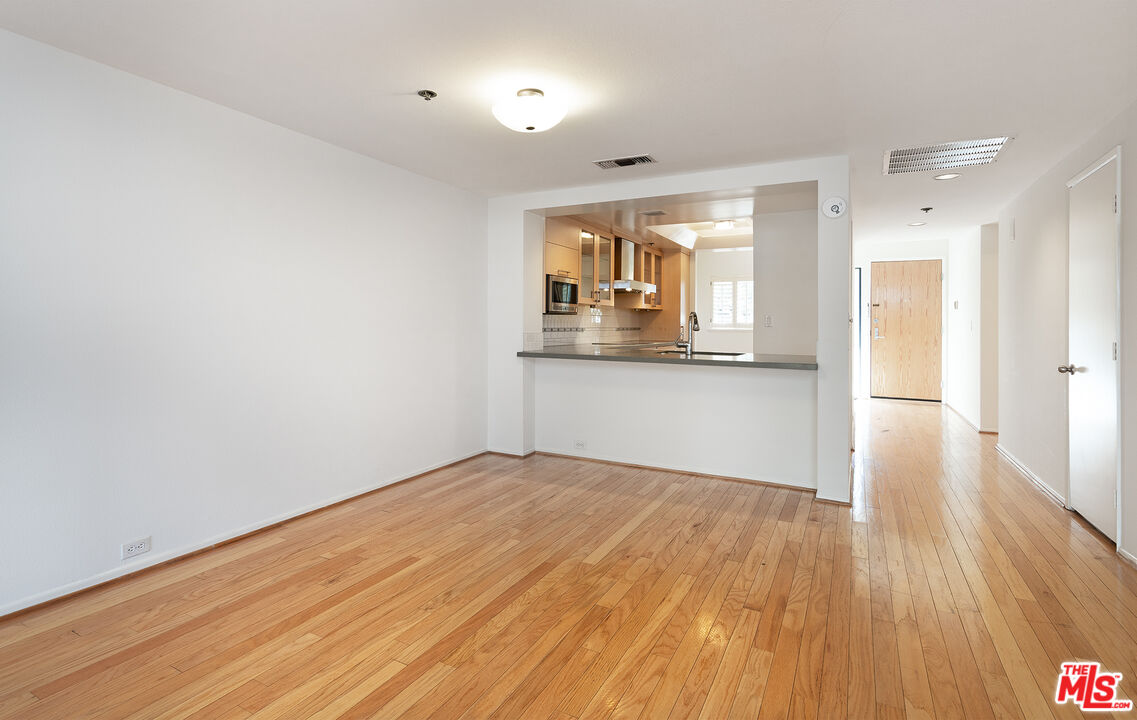 2910 Neilson Way, Unit 308 Santa Monica, CA 90405 - Photo 7 of 32 a view of a kitchen with wooden floor and a sink