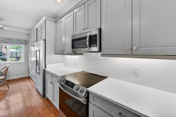 a kitchen with a sink cabinets and wooden floor