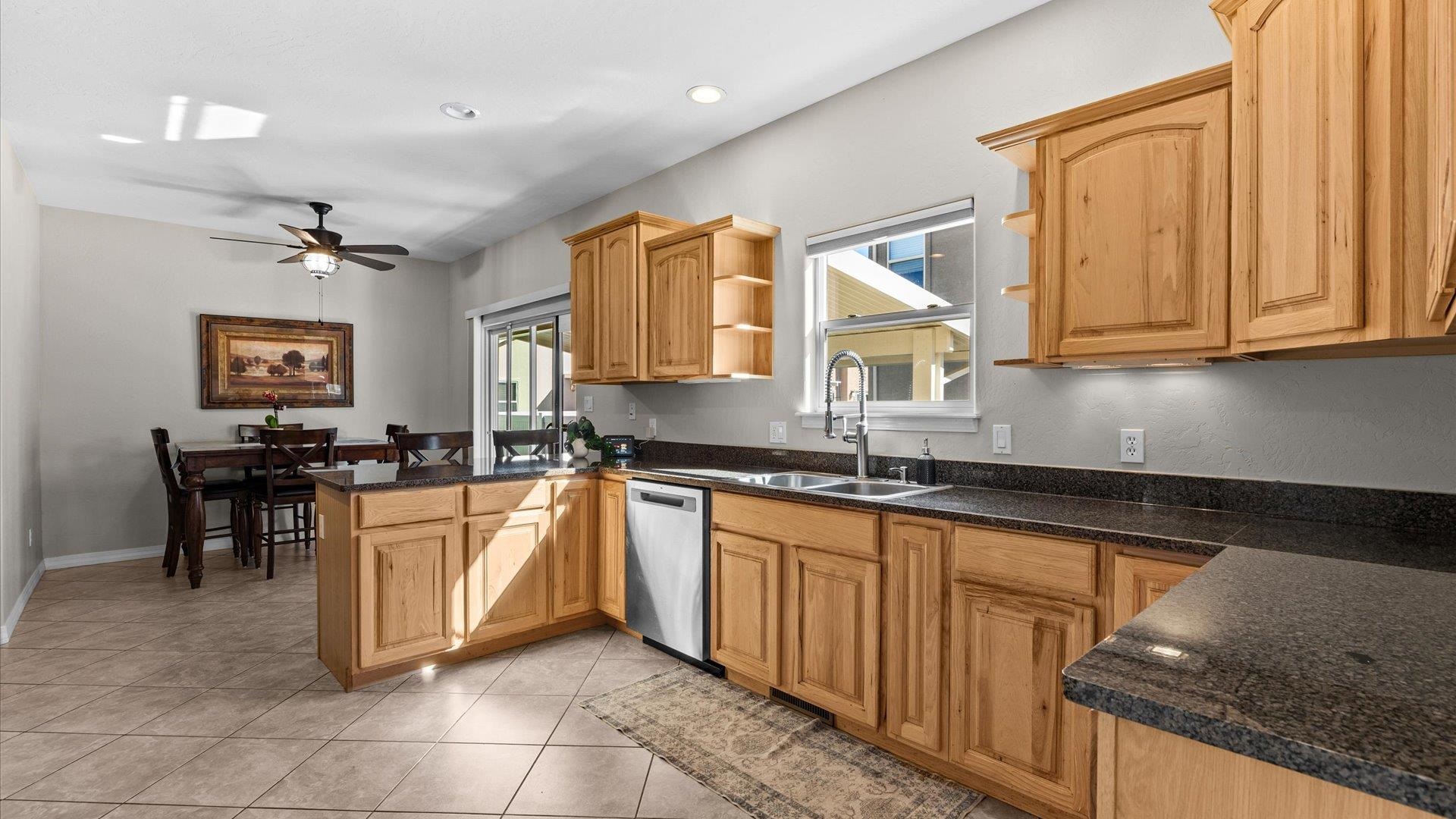 1427 Satterfield Avenue Fruita, CO 81521 - Photo 11 of 29 a kitchen with stainless steel appliances granite countertop a sink stove and cabinets