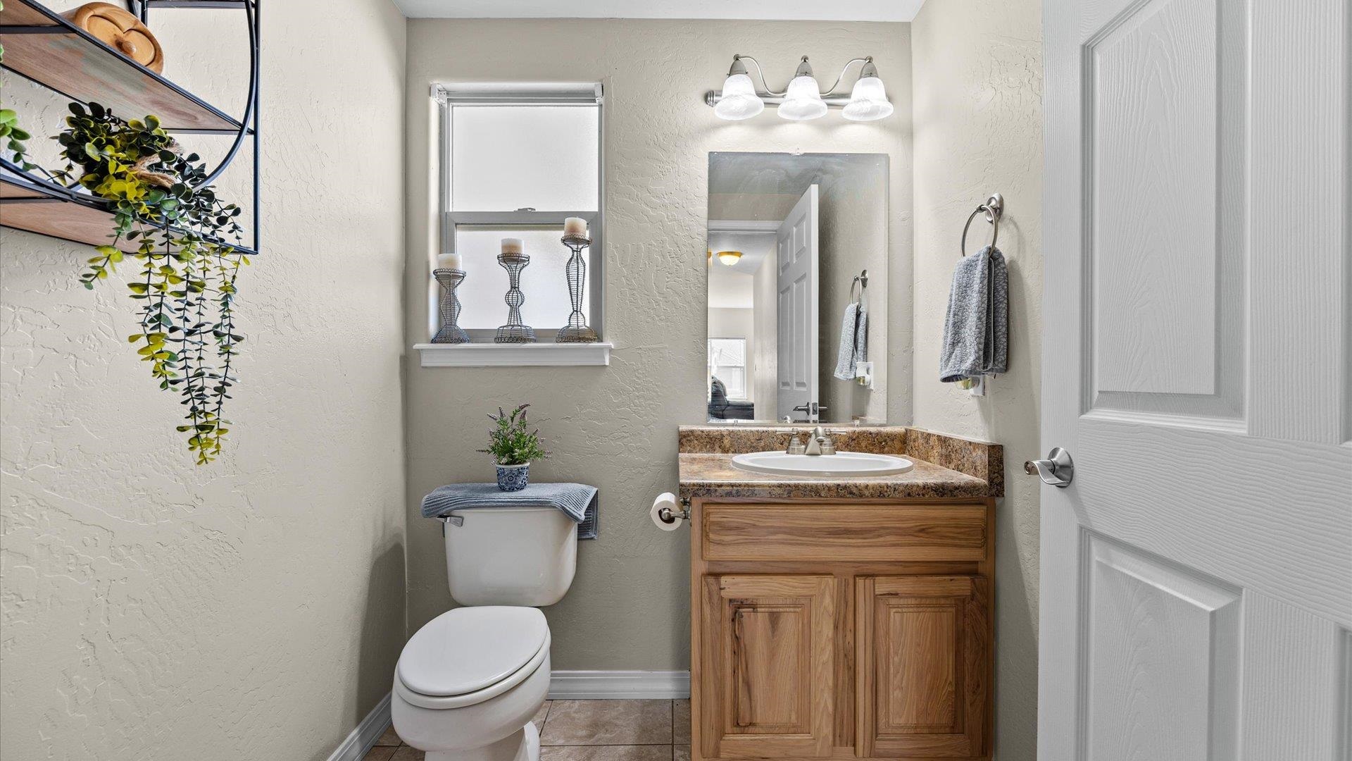 1427 Satterfield Avenue Fruita, CO 81521 - Photo 13 of 29 a bathroom with a toilet a sink and a mirror