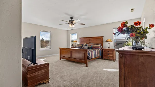 a bedroom with bed and a chandelier