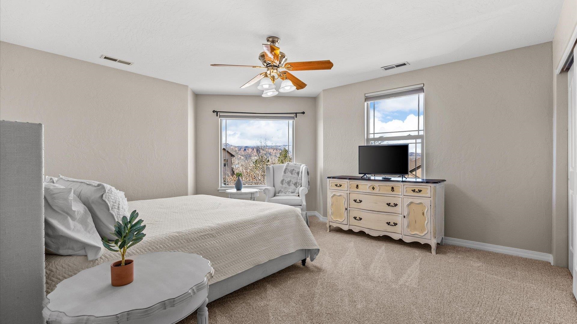 1427 Satterfield Avenue Fruita, CO 81521 - Photo 22 of 29 a bedroom with furniture and a flat screen tv