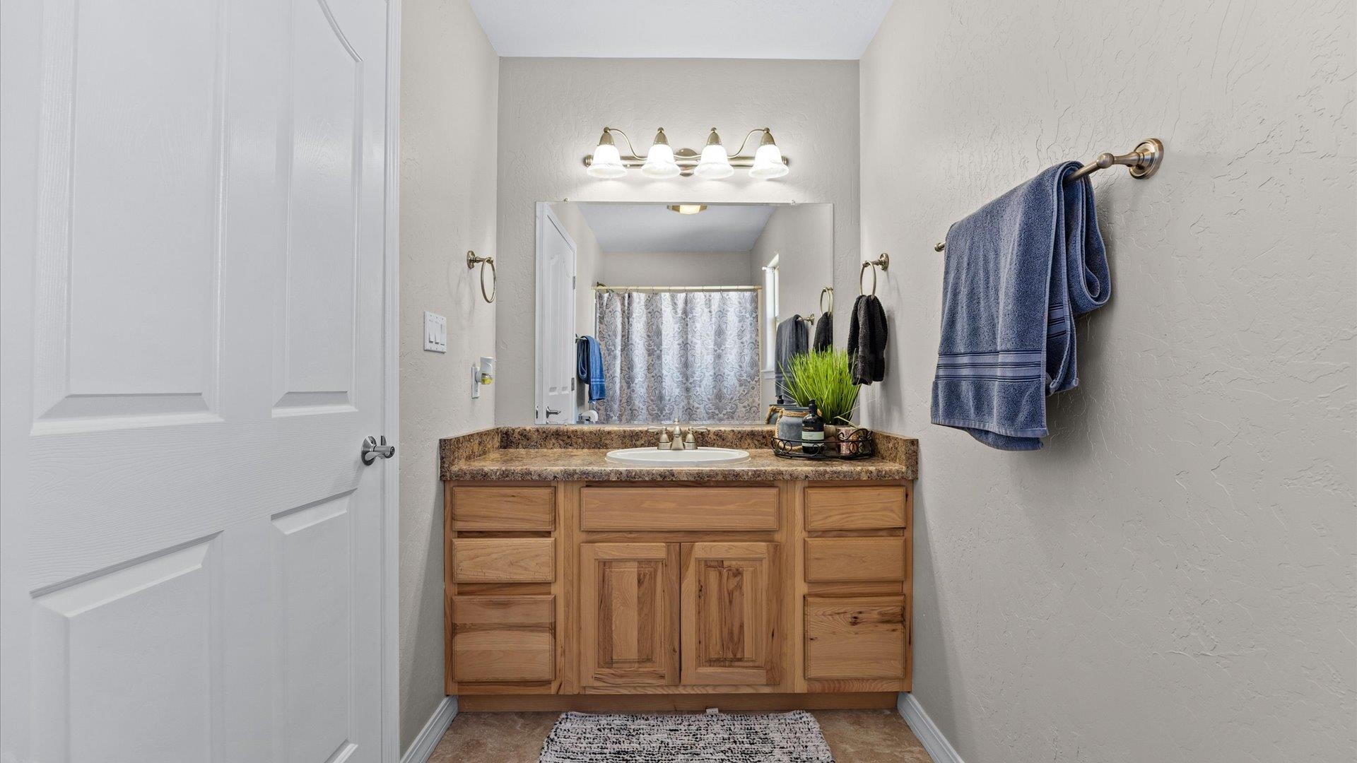1427 Satterfield Avenue Fruita, CO 81521 - Photo 23 of 29 a bathroom with a sink and a mirror