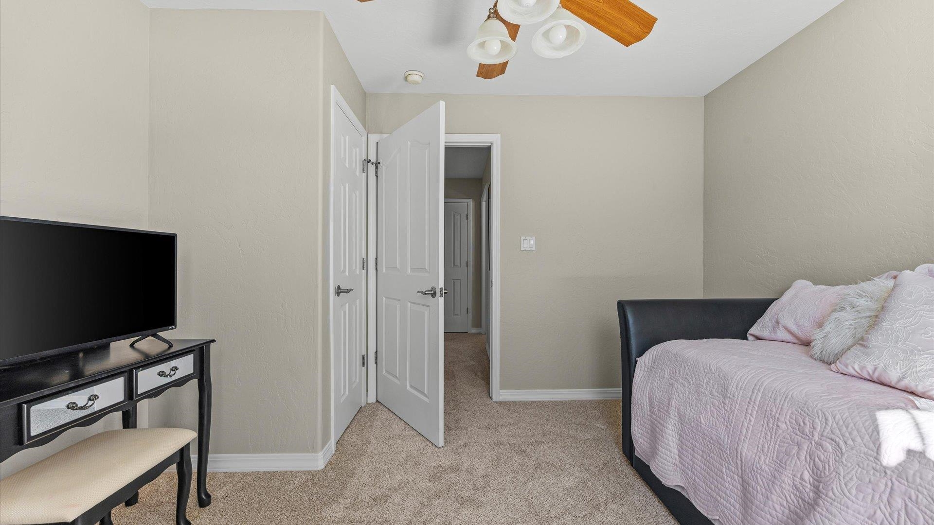 1427 Satterfield Avenue Fruita, CO 81521 - Photo 24 of 29 a bedroom with a bed and a flat screen tv