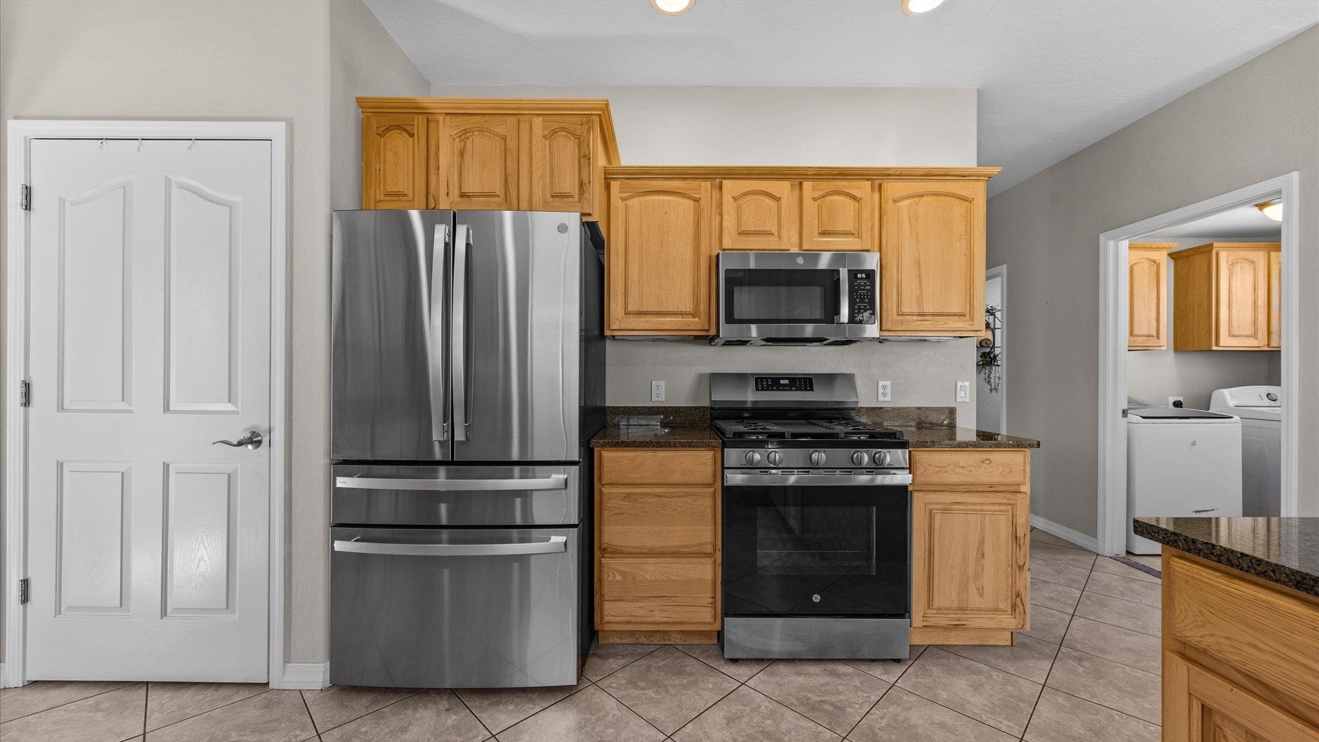 1427 Satterfield Avenue Fruita, CO 81521 - Photo 10 of 29 a kitchen with a refrigerator stove and microwave