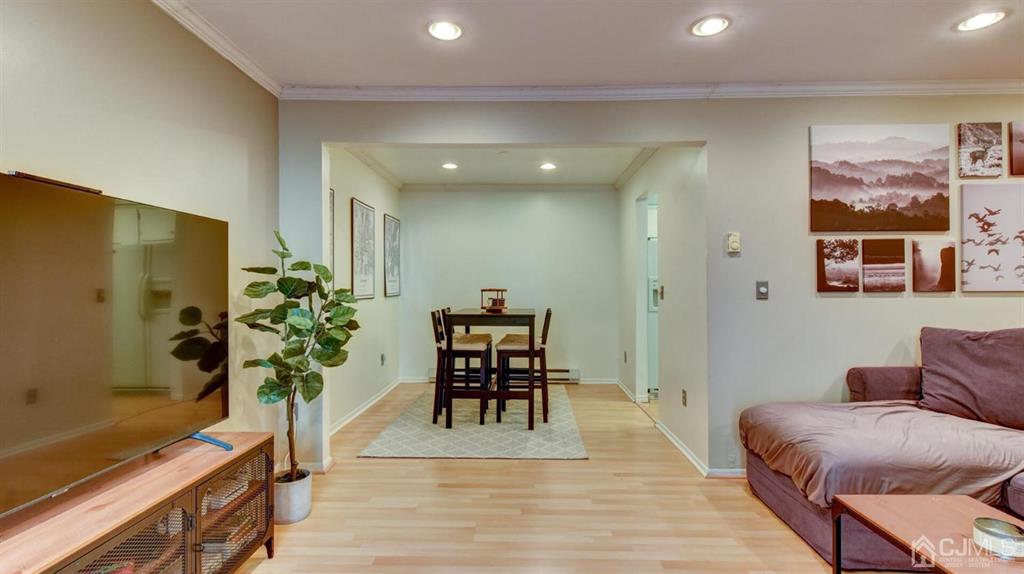 3 The Crescent Clinton, NJ 08809 - Photo 12 of 37 a living room with furniture a potted plant and open kitchen view