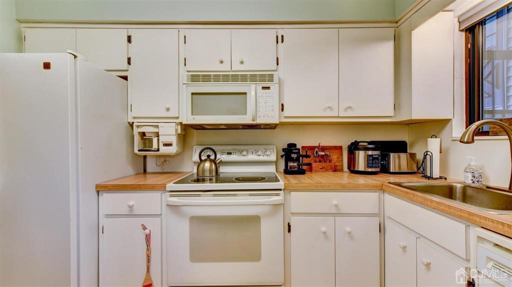 3 The Crescent Clinton, NJ 08809 - Photo 20 of 37 a kitchen with cabinets appliances and a sink
