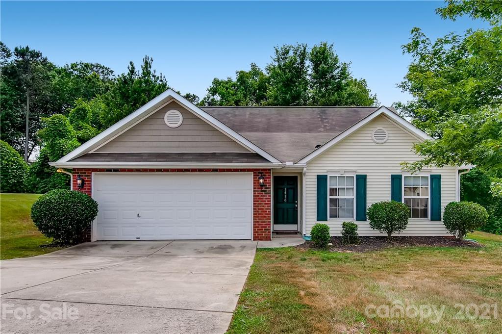 1416 Key Ridge Court Charlotte, NC 28216 - Photo 2 of 28 a front view of a house with a yard and garage