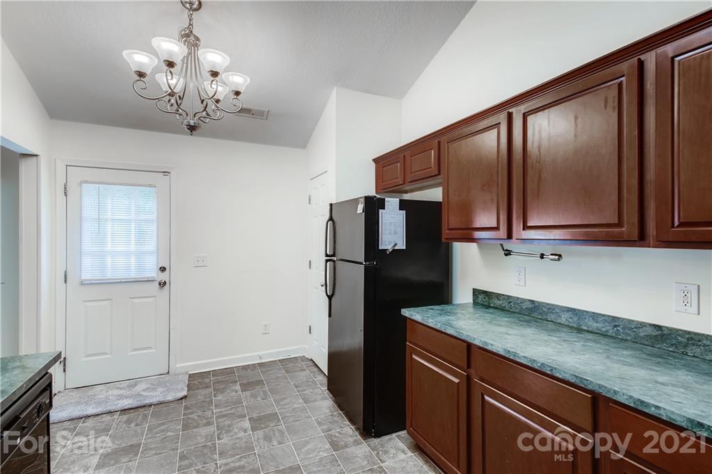 1416 Key Ridge Court Charlotte, NC 28216 - Photo 12 of 28 a kitchen with stainless steel appliances granite countertop a refrigerator a stove and a sink with granite countertops