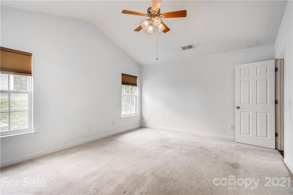 1416 Key Ridge Court Charlotte, NC 28216 - Photo 15 of 28 an empty room with windows and fan