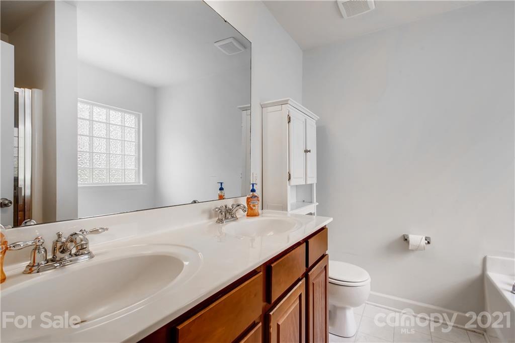1416 Key Ridge Court Charlotte, NC 28216 - Photo 16 of 28 a bathroom with a sink toilet and mirror