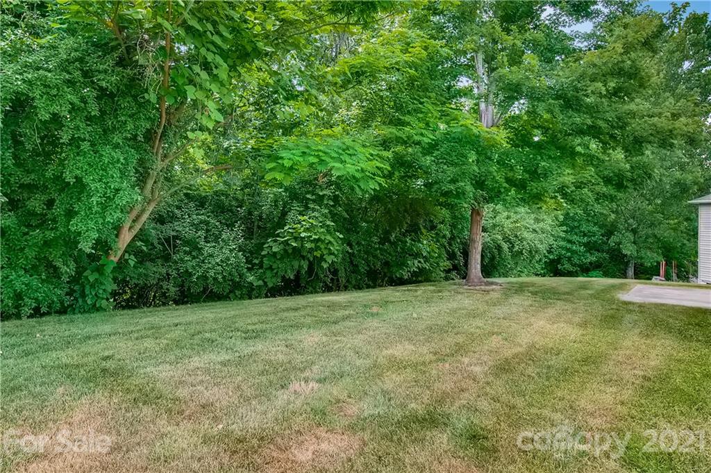 1416 Key Ridge Court Charlotte, NC 28216 - Photo 27 of 28 a view of a grassy field with trees in the background