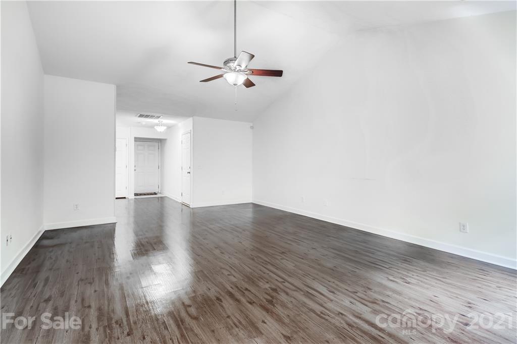 1416 Key Ridge Court Charlotte, NC 28216 - Photo 6 of 28 a view of a room with wooden floor and ceiling fan