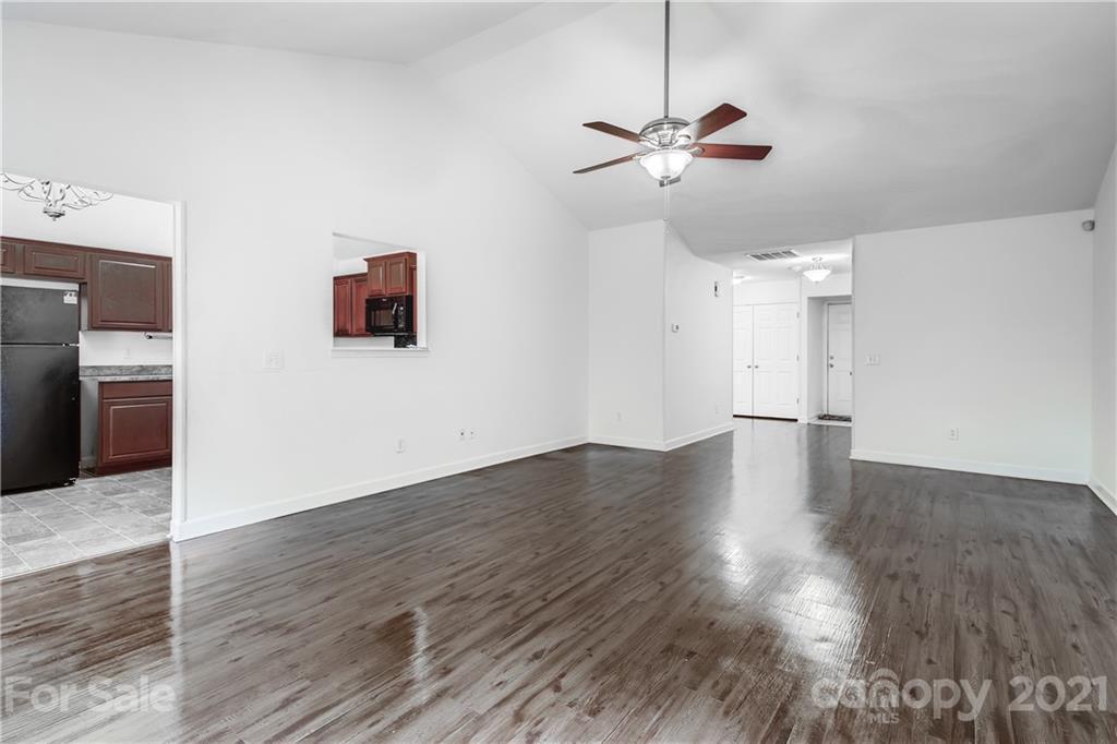 1416 Key Ridge Court Charlotte, NC 28216 - Photo 7 of 28 a view of a livingroom with wooden floor and a ceiling fan
