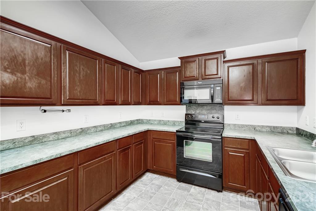 1416 Key Ridge Court Charlotte, NC 28216 - Photo 9 of 28 a kitchen with stainless steel appliances granite countertop a sink stove and cabinets
